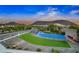 Community recreation area with blue water feature, green grass, and scenic views of surrounding mountains and desert landscape at 2324 E Saguaro Park Ln, Phoenix, AZ 85024