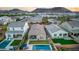 Aerial view of backyard featuring a pool, lounge area, and manicured lawn surrounded by homes at 2324 E Saguaro Park Ln, Phoenix, AZ 85024