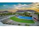 Community recreation area with a blue water feature, lush grass, and scenic views of surrounding mountains and desert landscape at 2324 E Saguaro Park Ln, Phoenix, AZ 85024