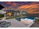 Relaxing backyard features a refreshing pool, patio seating, and lush green lawn perfect for outdoor entertainment at 2324 E Saguaro Park Ln, Phoenix, AZ 85024