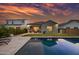 Inviting backyard with a sparkling pool, well-maintained lawn, and cozy patio seating, ideal for relaxing outdoors at 2324 E Saguaro Park Ln, Phoenix, AZ 85024