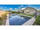 Spacious backyard featuring a sparkling swimming pool, a well-maintained lawn, and a cozy covered patio at 2324 E Saguaro Park Ln, Phoenix, AZ 85024