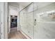 Elegant glass enclosed shower with built-in bench and adjacent walk-in closet at 2324 E Saguaro Park Ln, Phoenix, AZ 85024
