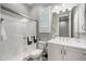 Bright bathroom with white cabinetry, sink, toilet, shower and chrome fixtures at 2324 E Saguaro Park Ln, Phoenix, AZ 85024