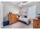 Well-lit bedroom with ceiling fan, window, and nice furniture at 2324 E Saguaro Park Ln, Phoenix, AZ 85024