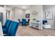 Open dining area with blue upholstered chairs, a modern table, and decor at 2324 E Saguaro Park Ln, Phoenix, AZ 85024
