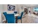 Cozy dining area with a round table and blue upholstered chairs at 2324 E Saguaro Park Ln, Phoenix, AZ 85024