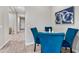Intimate dining area featuring blue velvet chairs and hardwood floors at 2324 E Saguaro Park Ln, Phoenix, AZ 85024