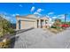 Paved driveway leading to a well-maintained home with a two-car garage, neat landscaping, and welcoming front porch at 2324 E Saguaro Park Ln, Phoenix, AZ 85024