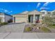 Attractive home features a welcoming front porch, a two-car garage, and low-maintenance landscaping at 2324 E Saguaro Park Ln, Phoenix, AZ 85024