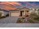 Charming home with a two-car garage, desert landscaping, and a cozy front porch seating area at 2324 E Saguaro Park Ln, Phoenix, AZ 85024