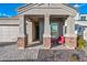 Close-up view of a charming front porch with stone accents, providing a cozy and inviting entrance to the home at 2324 E Saguaro Park Ln, Phoenix, AZ 85024