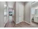 Bright hallway features modern flooring, neutral walls, and access to multiple rooms within the home at 2324 E Saguaro Park Ln, Phoenix, AZ 85024