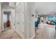 Inviting hallway with wood-look tile and views into other rooms at 2324 E Saguaro Park Ln, Phoenix, AZ 85024