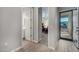Hallway view showcases a glimpse of an office space, bathroom, and the home's entryway, highlighting the layout at 2324 E Saguaro Park Ln, Phoenix, AZ 85024