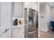 Modern kitchen with stainless steel refrigerator and white cabinetry at 2324 E Saguaro Park Ln, Phoenix, AZ 85024