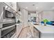 Bright, modern kitchen with stainless steel appliances and white cabinetry at 2324 E Saguaro Park Ln, Phoenix, AZ 85024