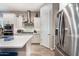 Well-appointed kitchen with stainless steel appliances and white cabinets at 2324 E Saguaro Park Ln, Phoenix, AZ 85024