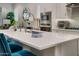 Beautiful kitchen island with stainless steel faucet and ample space, enhanced by elegant white cabinetry at 2324 E Saguaro Park Ln, Phoenix, AZ 85024