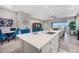 Spacious open kitchen with an island, stainless steel sink, and blue chairs at the breakfast bar at 2324 E Saguaro Park Ln, Phoenix, AZ 85024