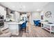 Open-concept kitchen and dining area with hardwood floors and island seating at 2324 E Saguaro Park Ln, Phoenix, AZ 85024