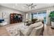 Inviting living room with comfortable seating, a large TV, and sliding doors to the outdoor area at 2324 E Saguaro Park Ln, Phoenix, AZ 85024