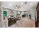 Expansive living room open to the kitchen with hardwood floors, and comfortable, stylish furniture at 2324 E Saguaro Park Ln, Phoenix, AZ 85024