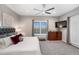 Well-lit main bedroom features plush carpet, a ceiling fan, and a mounted television at 2324 E Saguaro Park Ln, Phoenix, AZ 85024