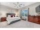 Comfortable main bedroom featuring a neutral color palette, ceiling fan, and natural light at 2324 E Saguaro Park Ln, Phoenix, AZ 85024
