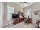 Traditional home office features a built-in desk, wood cabinets, neutral walls, and fan at 2324 E Saguaro Park Ln, Phoenix, AZ 85024