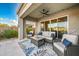Covered patio featuring comfortable seating and a ceiling fan, perfect for outdoor lounging at 2324 E Saguaro Park Ln, Phoenix, AZ 85024