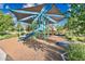 Playground area featuring a shaded jungle gym, slide, climbing structure, and mulch ground cover at 2324 E Saguaro Park Ln, Phoenix, AZ 85024