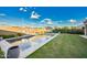 Beautiful swimming pool with a view, enhanced by a manicured lawn, patio area, and desert landscaping at 2324 E Saguaro Park Ln, Phoenix, AZ 85024