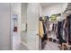 Walk-in closet offers ample storage space with organized shelving and hanging racks at 2324 E Saguaro Park Ln, Phoenix, AZ 85024