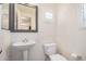 Bathroom features a pedestal sink, framed mirror, toilet, shuttered window, and neutral paint at 2401 E Rio Salado Pkwy # 1048, Tempe, AZ 85288