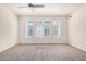Bright, carpeted bedroom with windows providing natural light and ceiling fan at 2401 E Rio Salado Pkwy # 1048, Tempe, AZ 85288