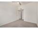 This is a bedroom with carpet, ceiling fan, light walls, and a doorway leading to another room at 2401 E Rio Salado Pkwy # 1048, Tempe, AZ 85288