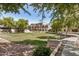 Green community space with mature trees, walking path, and well-maintained landscaping at 2401 E Rio Salado Pkwy # 1048, Tempe, AZ 85288