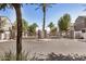 Community gate entrance with mature trees, clean streets, and well-maintained landscaping at 2401 E Rio Salado Pkwy # 1048, Tempe, AZ 85288