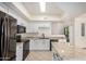 Bright kitchen features granite countertops, black appliances, an island, and white cabinetry at 2401 E Rio Salado Pkwy # 1048, Tempe, AZ 85288
