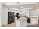 Bright kitchen features granite countertops, black appliances, an island, and white cabinetry at 2401 E Rio Salado Pkwy # 1048, Tempe, AZ 85288