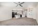 Open-concept living area with modern ceiling fan, carpet and adjacent kitchen at 2401 E Rio Salado Pkwy # 1048, Tempe, AZ 85288