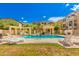 Sparkling community pool surrounded by lounge chairs, pergolas, and lush landscaping at 2401 E Rio Salado Pkwy # 1048, Tempe, AZ 85288