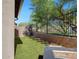 Lush backyard with artificial grass, complemented by a modern outdoor fire pit, ideal for relaxation at 2412 W Gloria Ln, Phoenix, AZ 85085