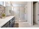 Modern bathroom with a double sink vanity, tiled shower, and clean, contemporary design at 2412 W Gloria Ln, Phoenix, AZ 85085