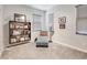 Well-lit bedroom with a cozy chaise lounge and large bookshelf, perfect for relaxing and reading at 2412 W Gloria Ln, Phoenix, AZ 85085