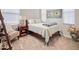Cozy bedroom features a comfortable bed, a bedside table with a lamp, and natural light from the windows at 2412 W Gloria Ln, Phoenix, AZ 85085