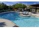 Sparkling community pool with lounge chairs, tables, and umbrellas for residents to enjoy at 2412 W Gloria Ln, Phoenix, AZ 85085