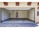 Spacious two-car garage with ample room for parking and storage, featuring smooth concrete flooring at 2412 W Gloria Ln, Phoenix, AZ 85085