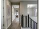 Well-lit hallway with wood-look floors and neutral walls, leading to other rooms in the home at 2412 W Gloria Ln, Phoenix, AZ 85085